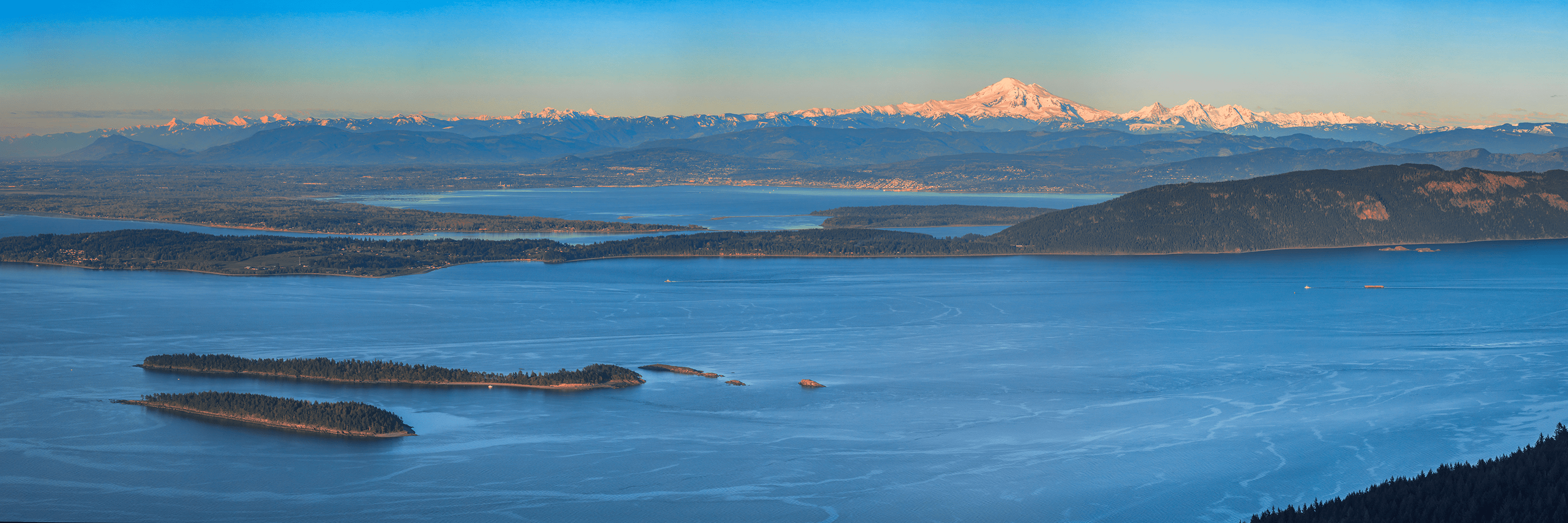 From above image of San Juan Islands, the sea and mountain range in distance
